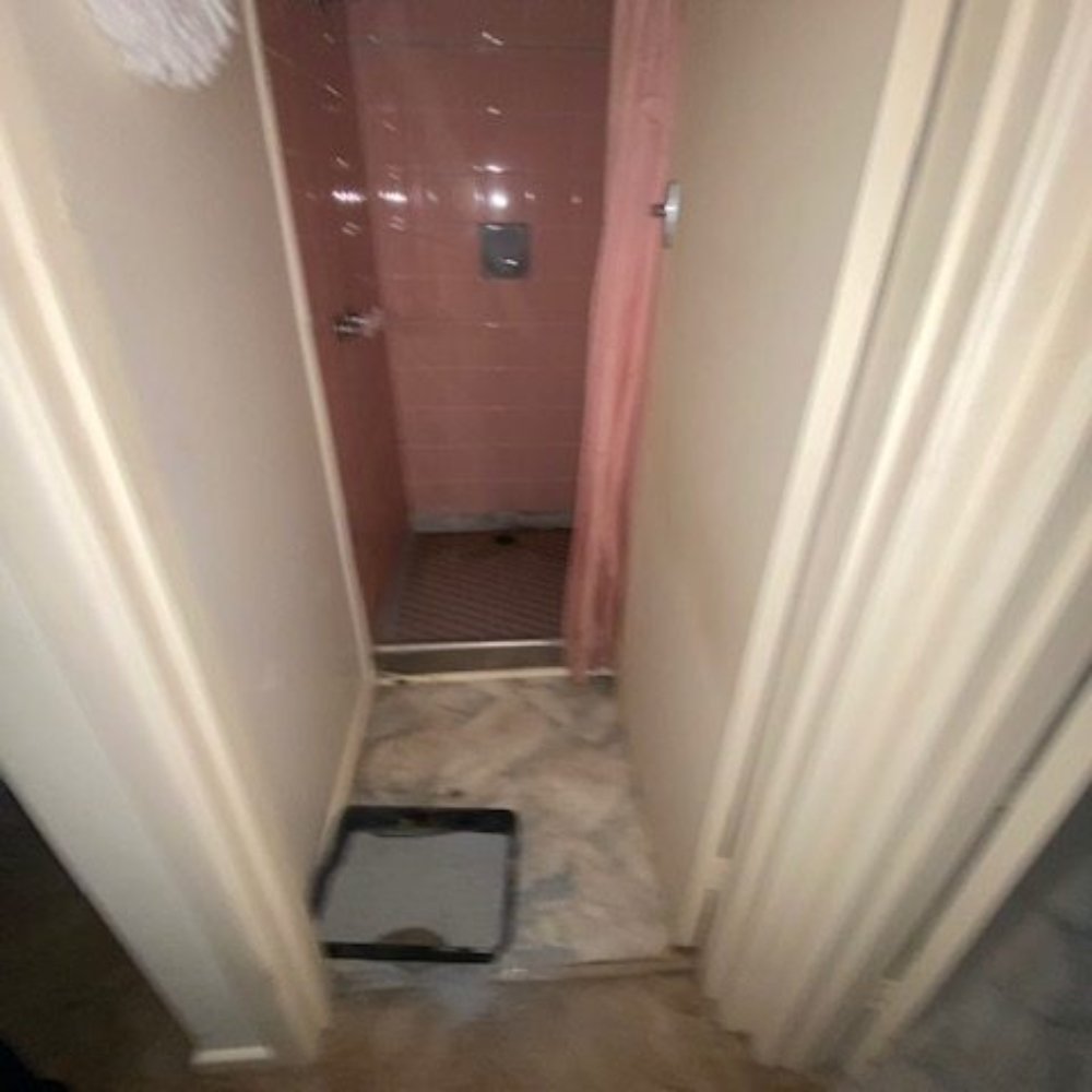 A worn-out space with peeling paint, cracked walls, and outdated fixtures before renovation.