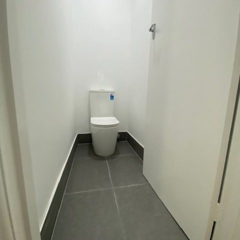 Modern bathroom renovation with sleek white tiles