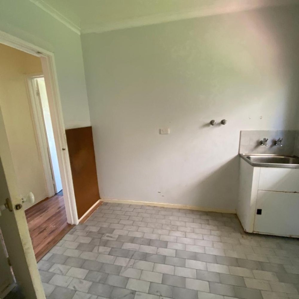 Outdated room featuring old fixtures and faded paint
